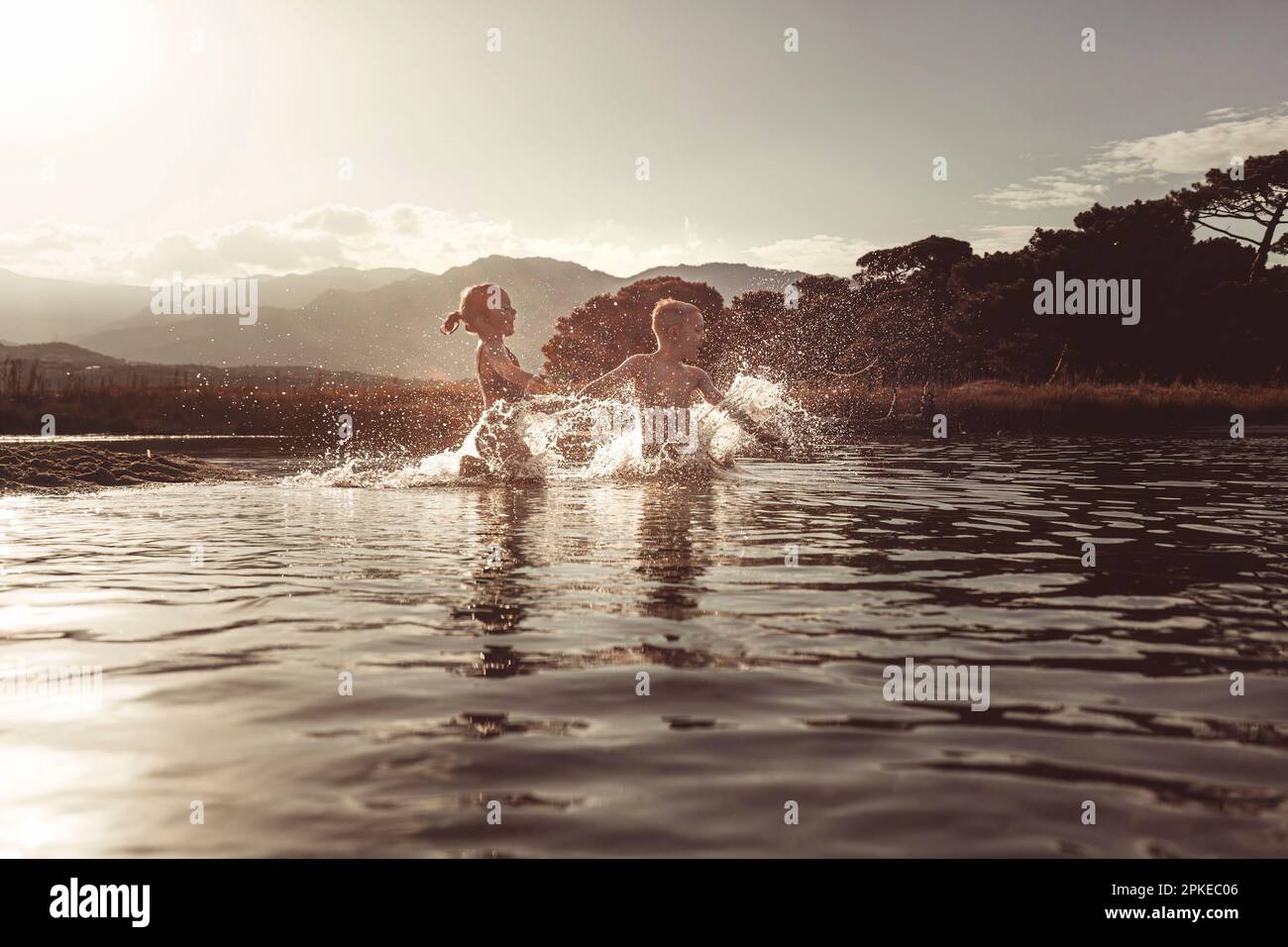 children play in the sea making big splashes of water Stock Photo - Alamy