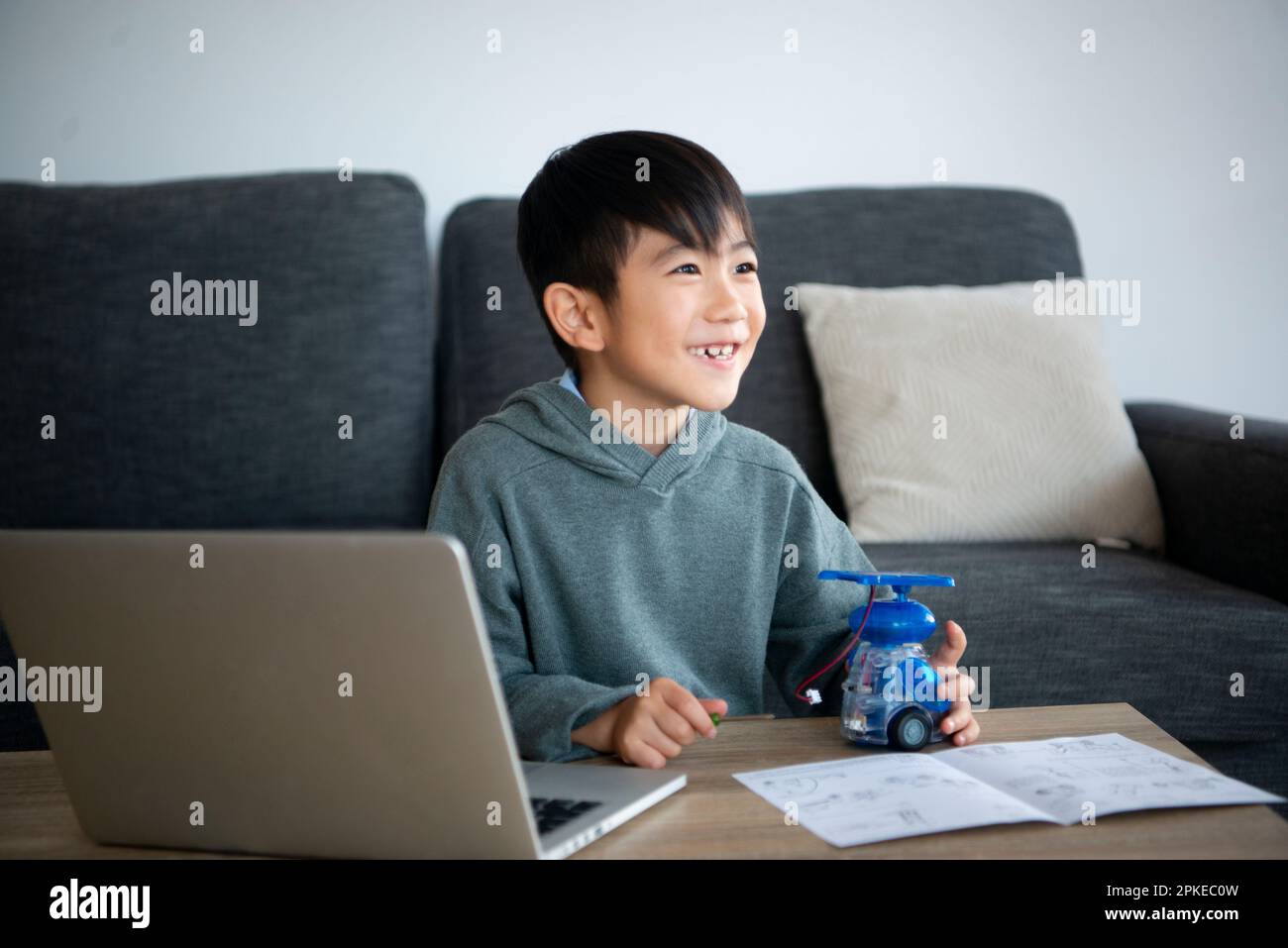Smiling boy making a robot Stock Photo