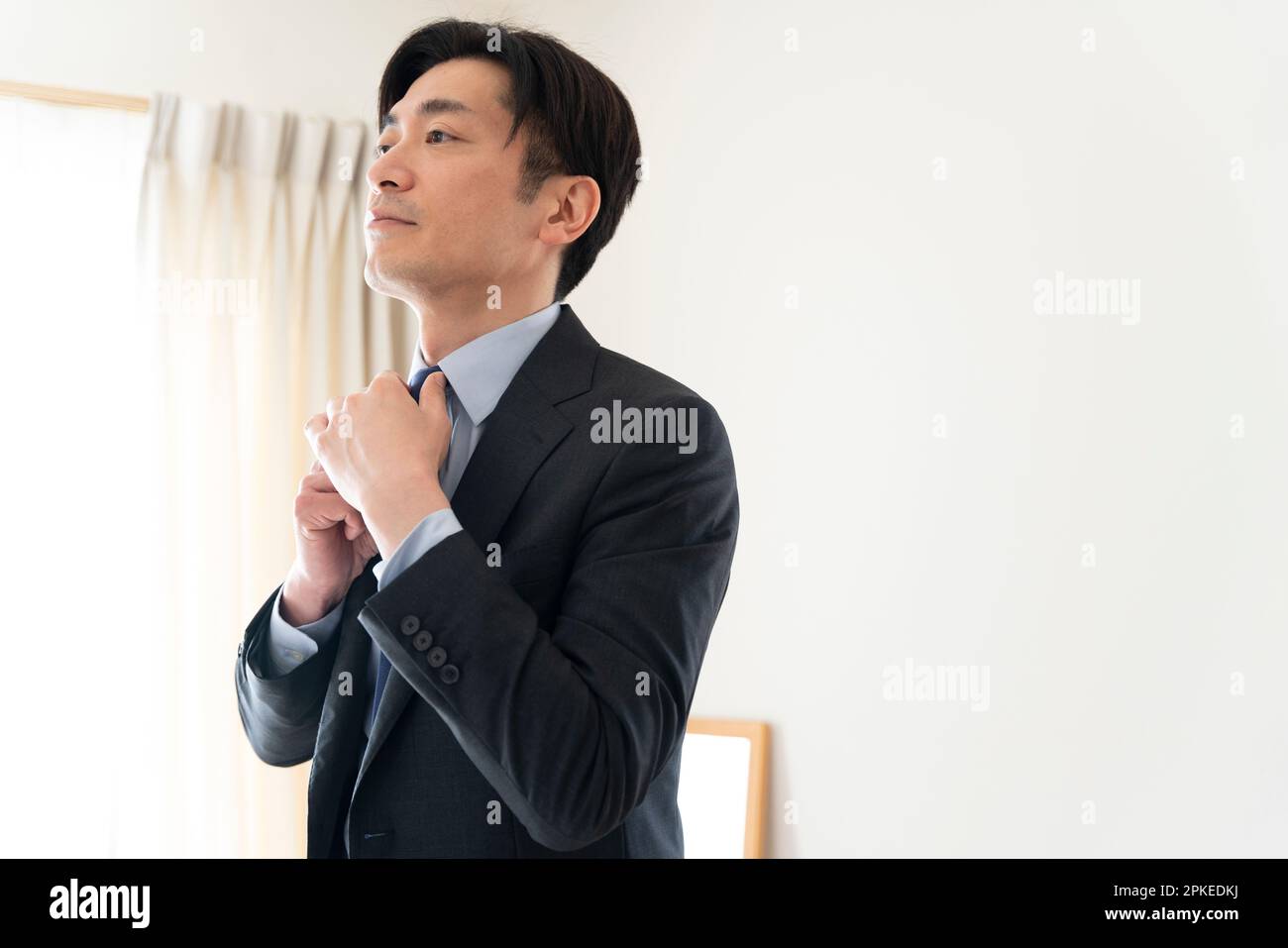 Man wearing tie at home Stock Photo