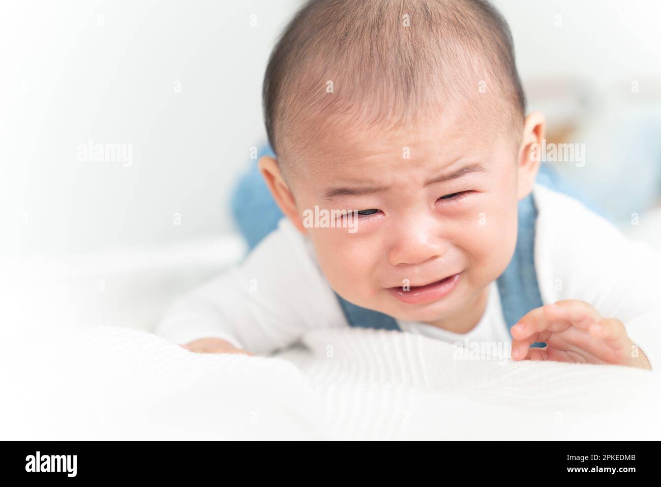 Baby crying on belly Stock Photo