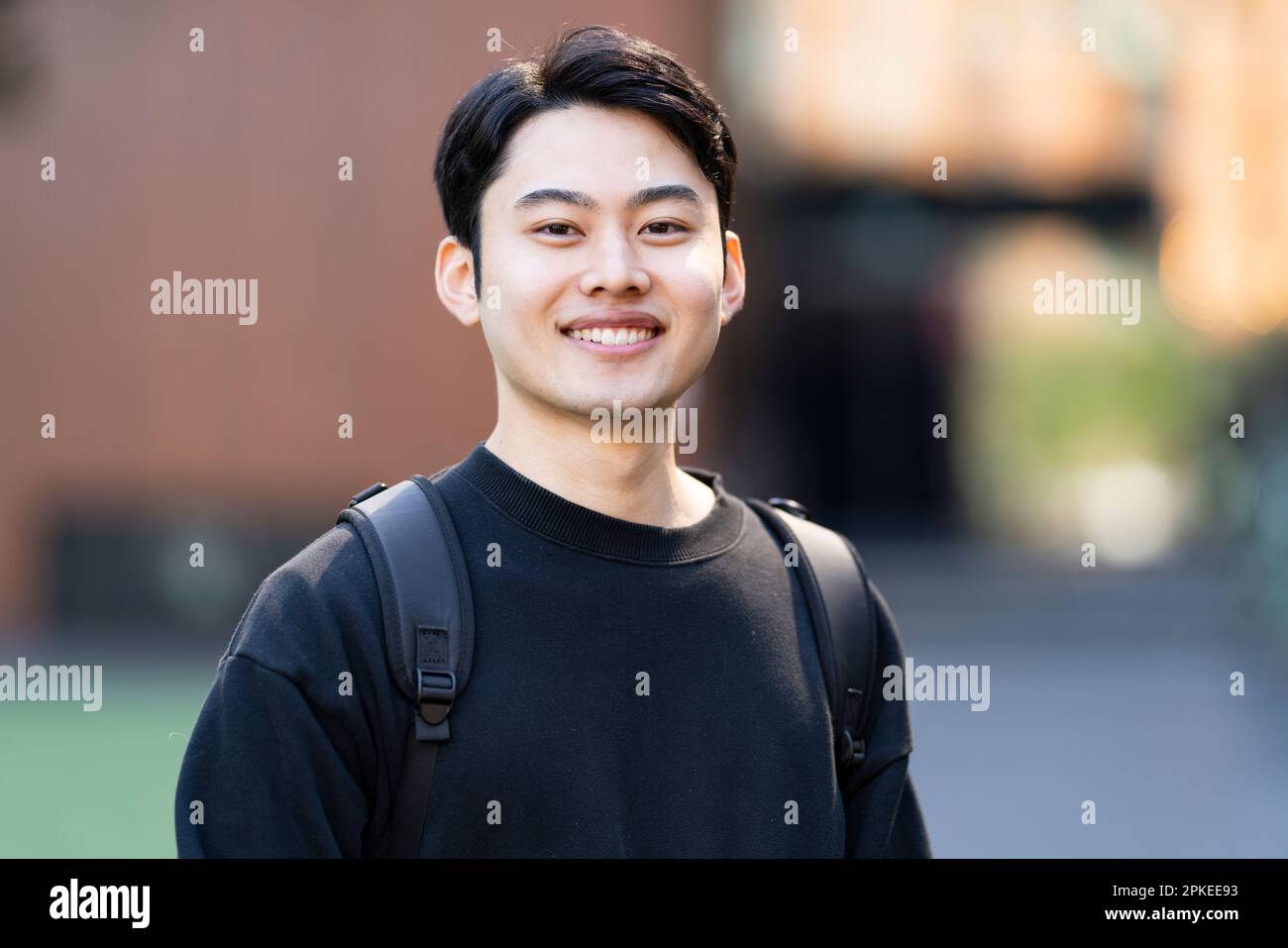 Asian young man smiling outside hi-res stock photography and images - Alamy