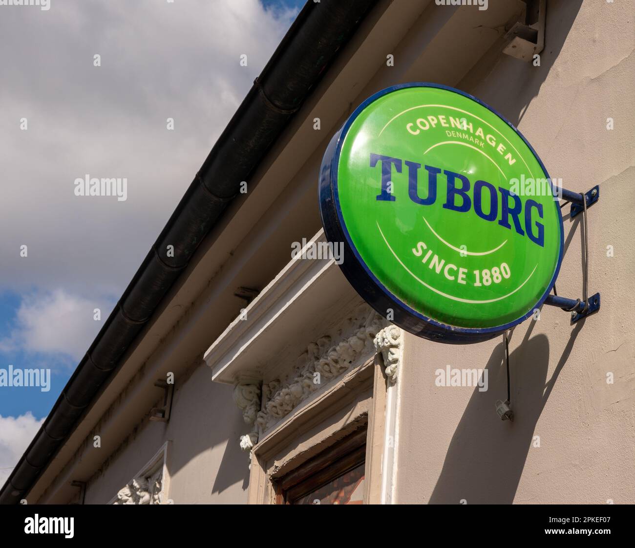 Hanging signboard Tuborg beer on street in european town. Novi Sad, Serbia - 28 March 2023 Stock Photo
