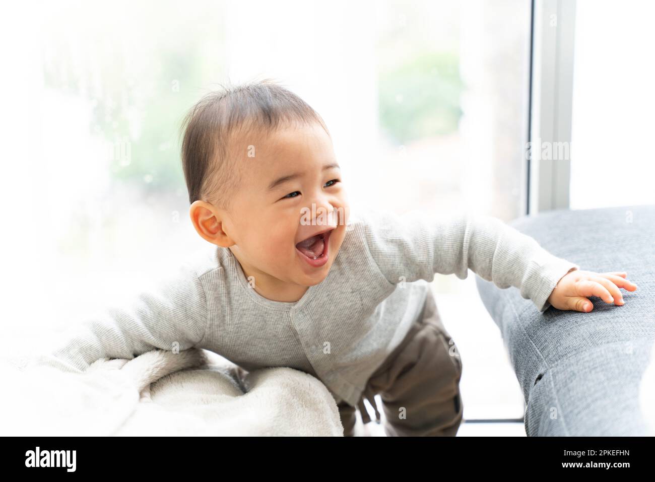 Baby boy laughing in house Stock Photo
