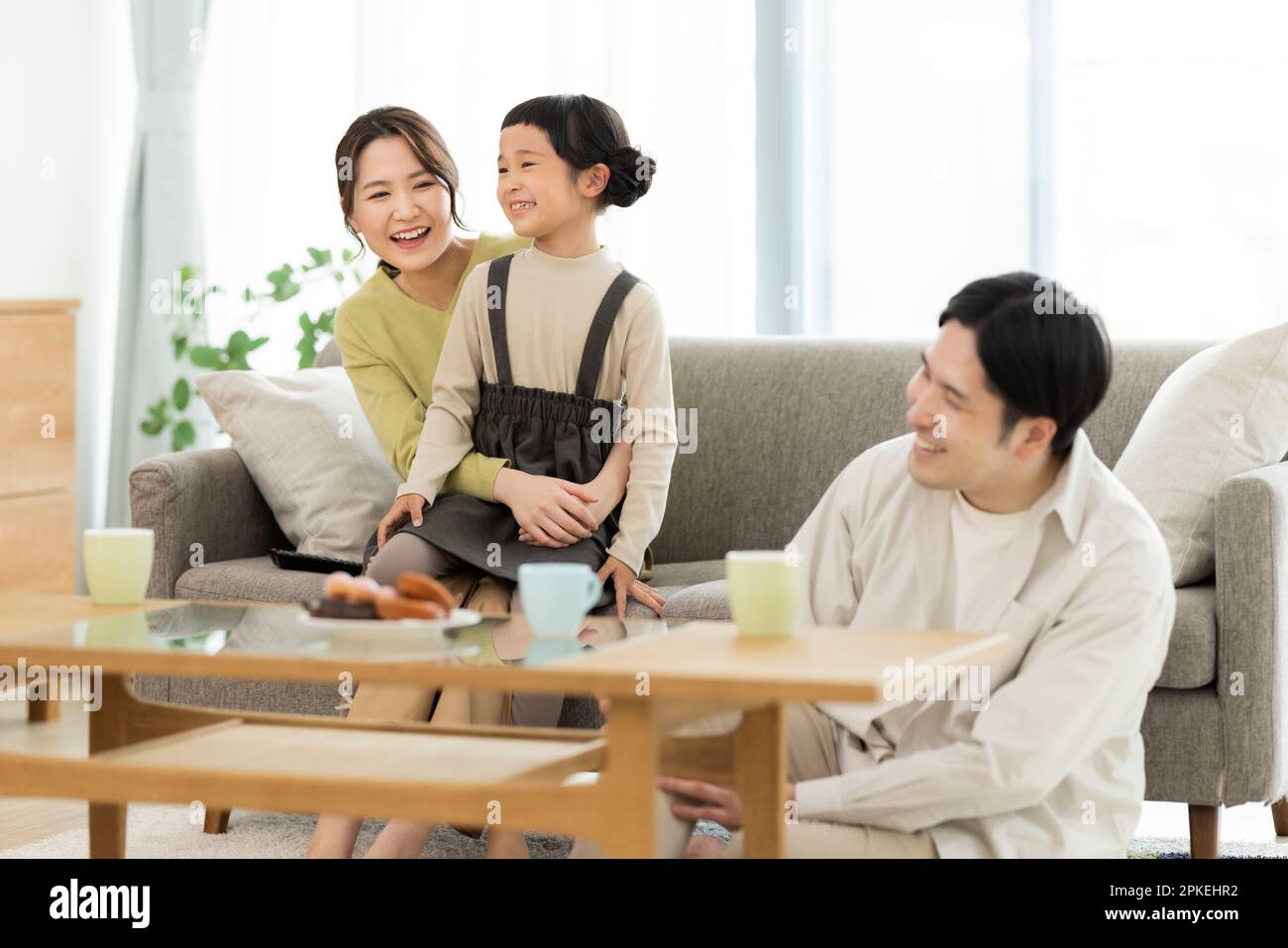Family in the living room Stock Photo - Alamy