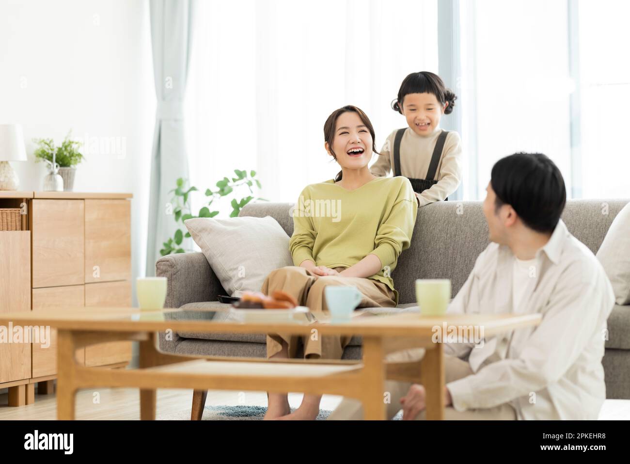 Family in the living room Stock Photo - Alamy