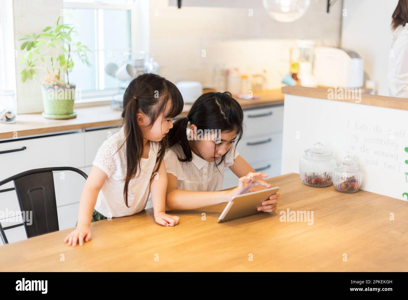Sisters playing with a tablet Stock Photo