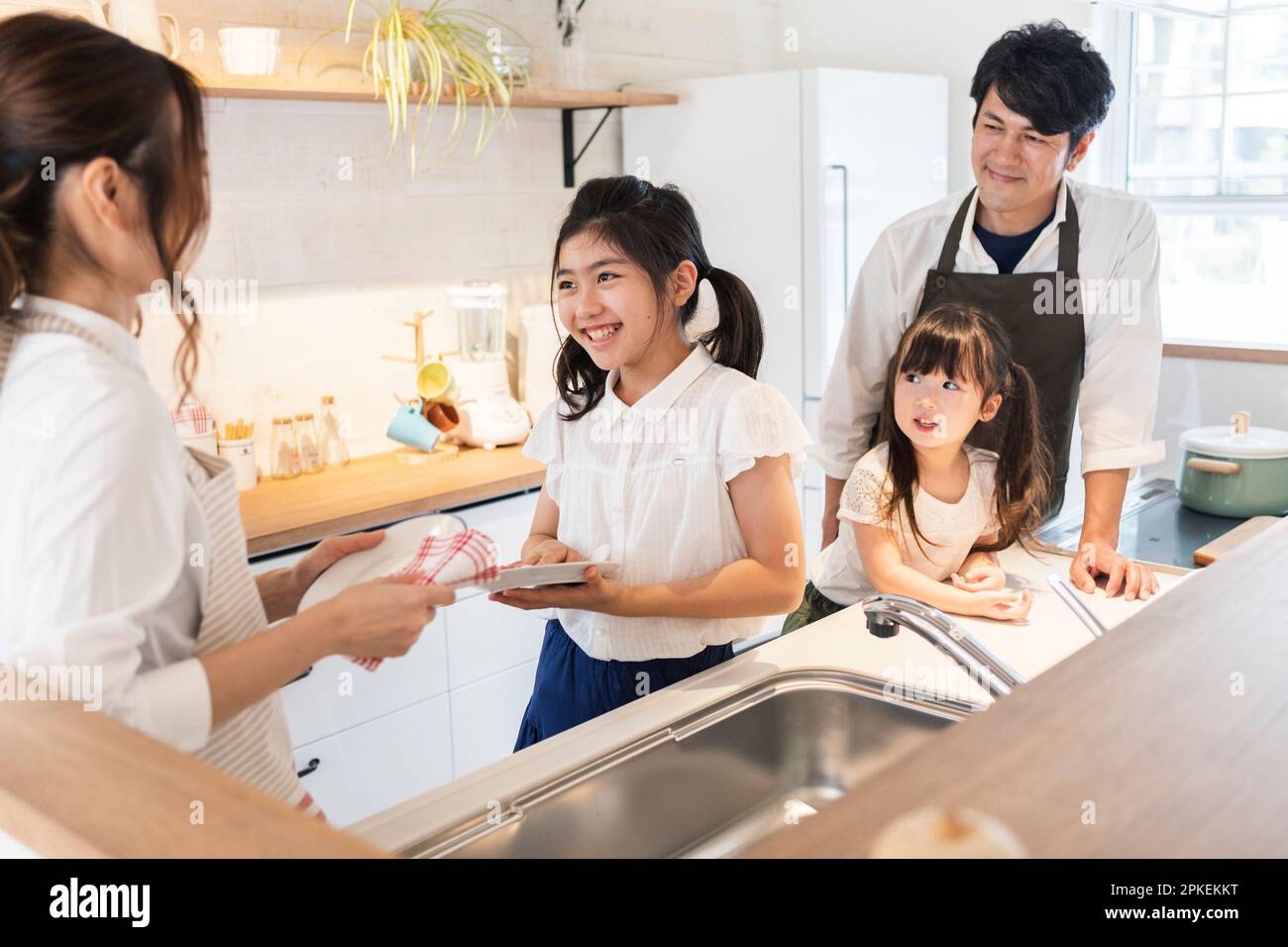 Mother and Daughter Wiping Dish Stock Photo Alamy