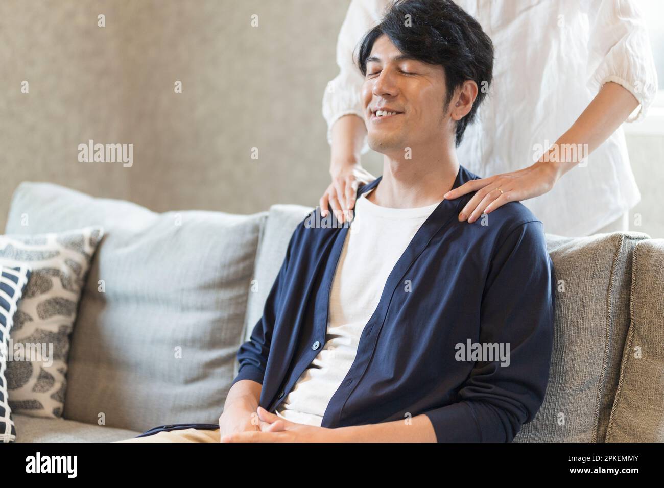 Wife rubbing husband's shoulder Stock Photo - Alamy