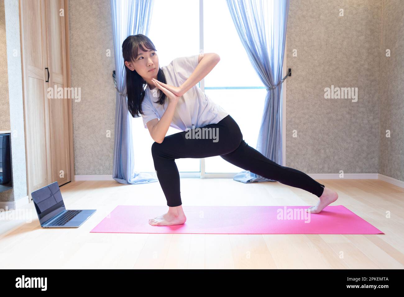 Sporty Asian Girl Standing In Yoga Asana On Mat Against Concrete Stock  Photo - Download Image Now - iStock