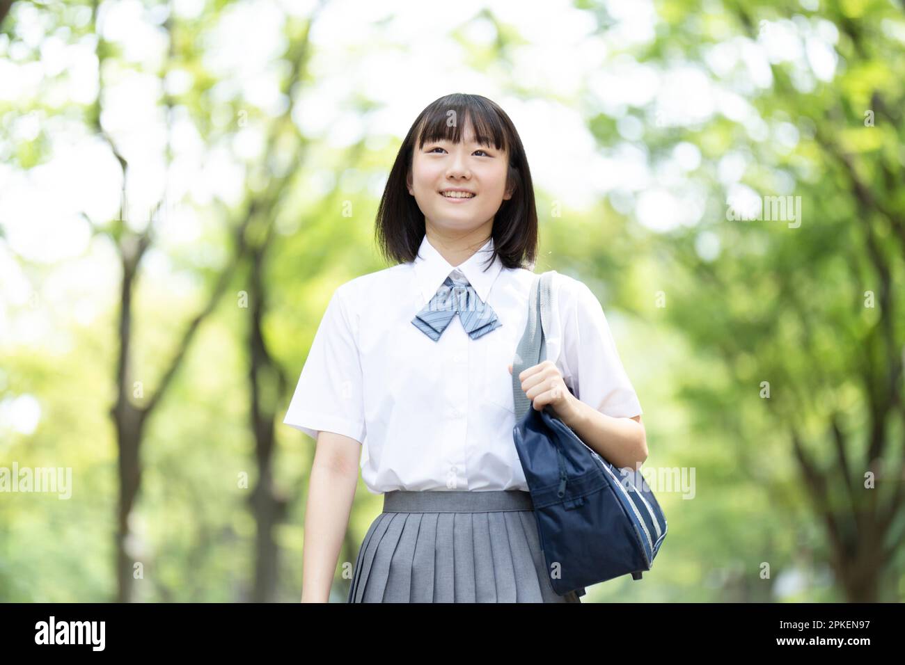 High school girl walking in the park Stock Photo - Alamy
