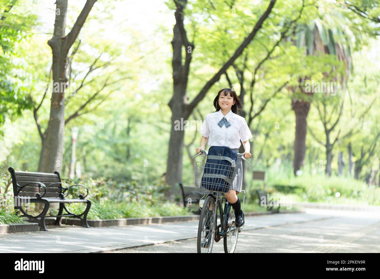 High school girl riding a bicycle Stock Photo - Alamy