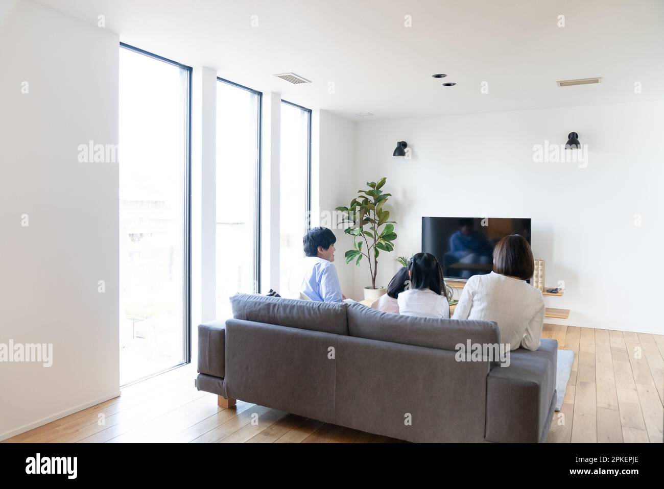 Family in the living room Stock Photo - Alamy