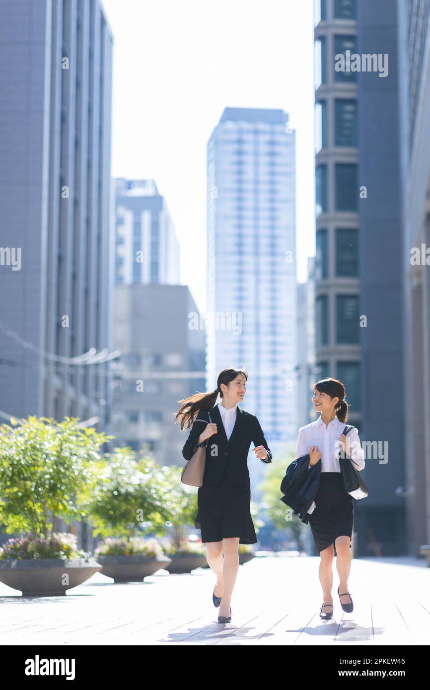 Woman running in suit Stock Photo Alamy
