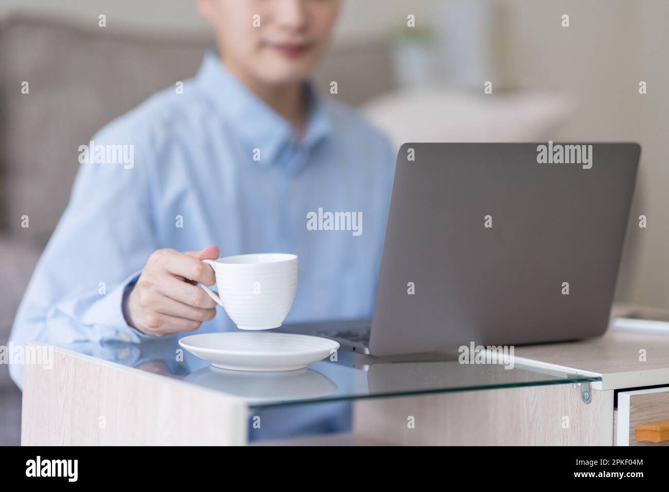 Man's hand holding a cup Stock Photo