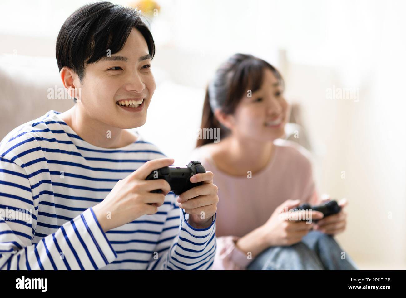Young asian couple playing games hi-res stock photography and images ...