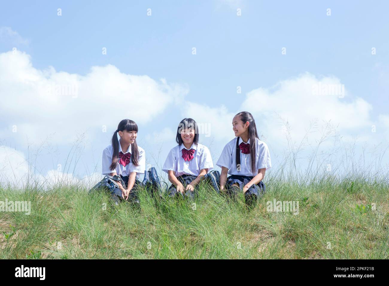 Junior High School Students Sitting on the Bank Stock Photo