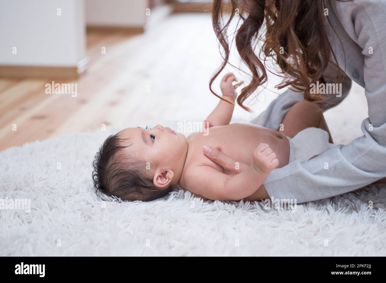 Mother taking care of baby Stock Photo Alamy