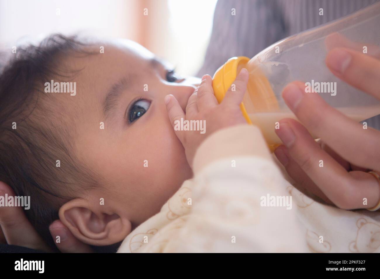 Baby drinking milk from a bottle Stock Photo Alamy