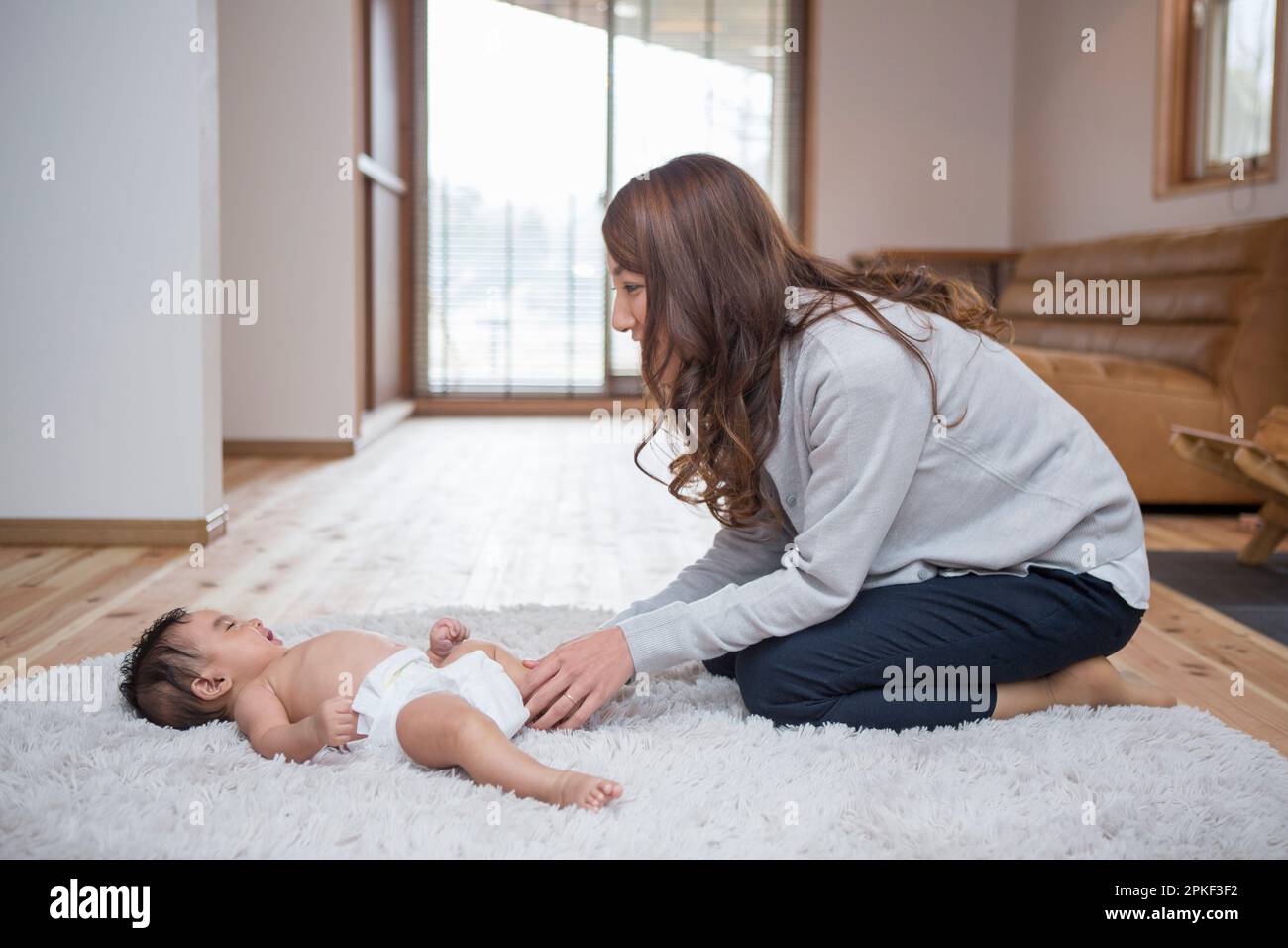 Mother taking care of baby Stock Photo Alamy