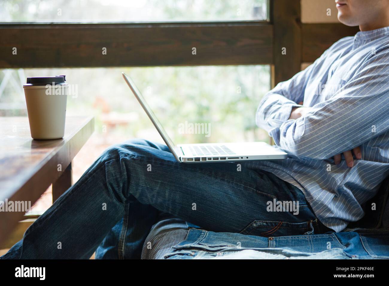 Man using computer at café Stock Photo