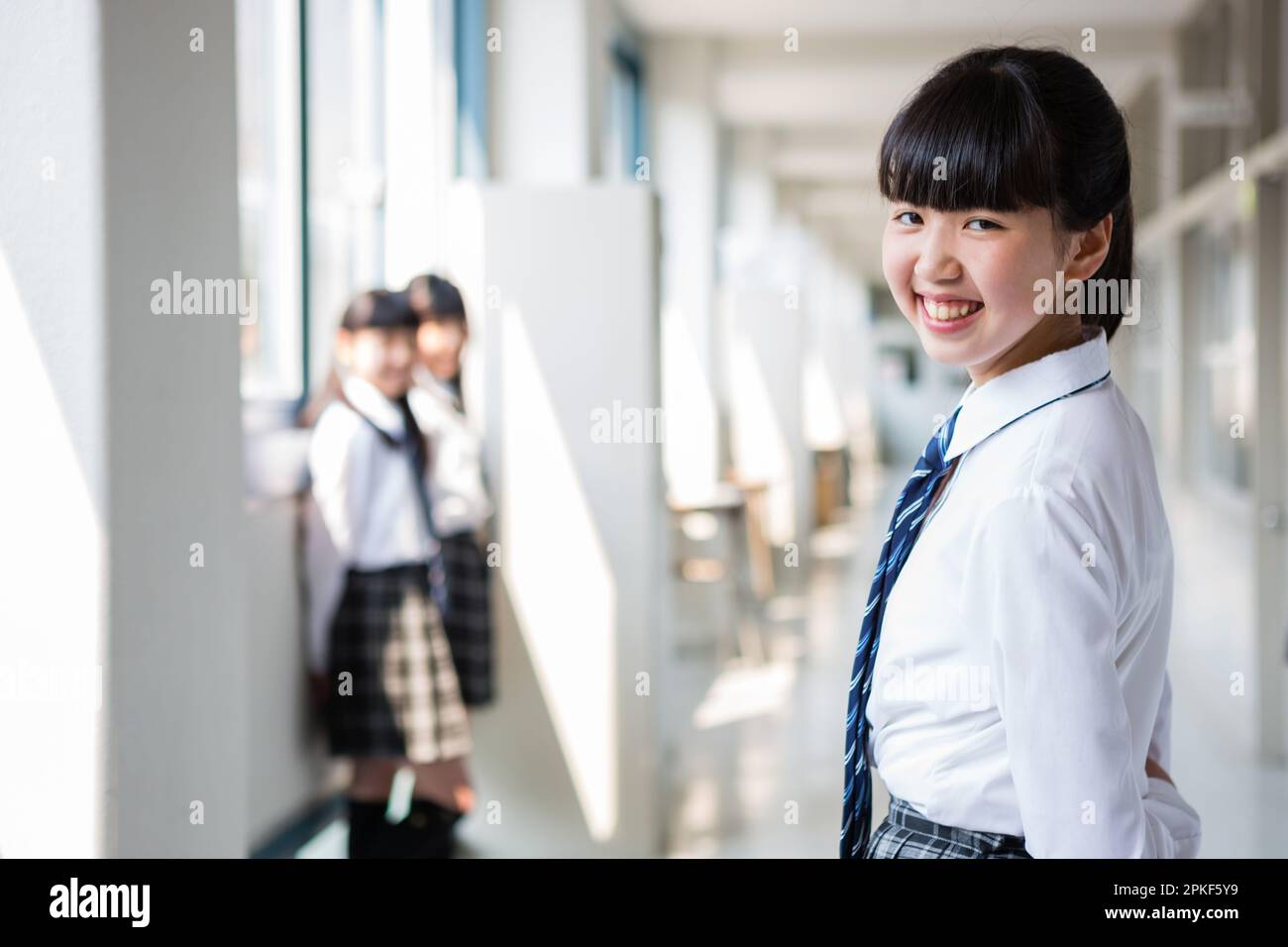 Junior High School Girls Standing in the Hallway Stock Photo