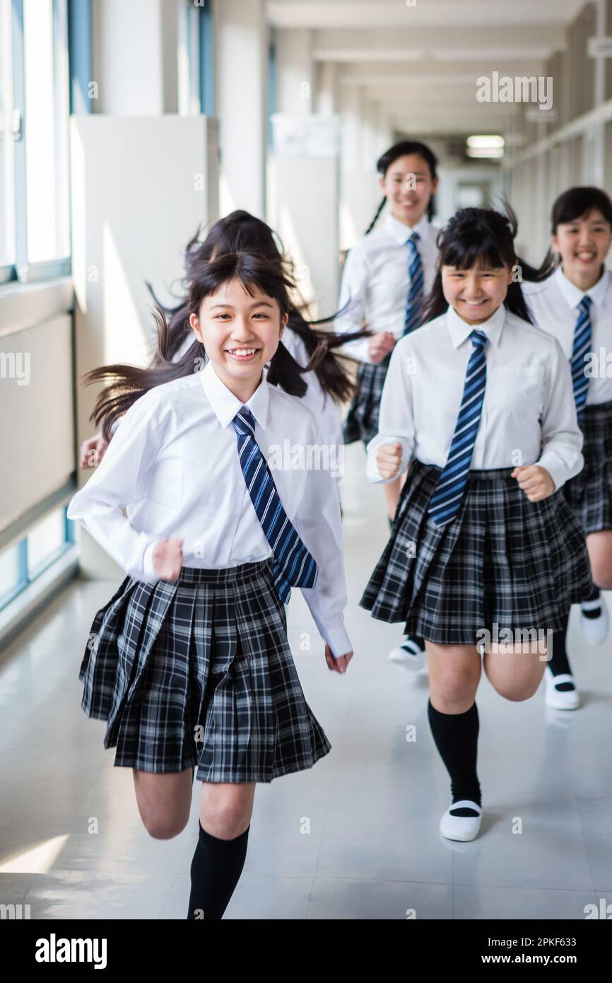 Junior High School Girl Running in the Hallway Stock Photo