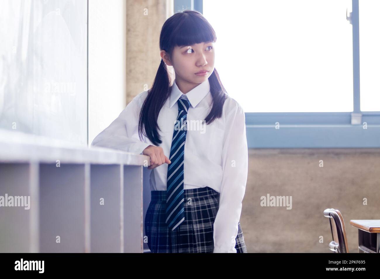 A junior high school girl standing in a classroom Stock Photo - Alamy
