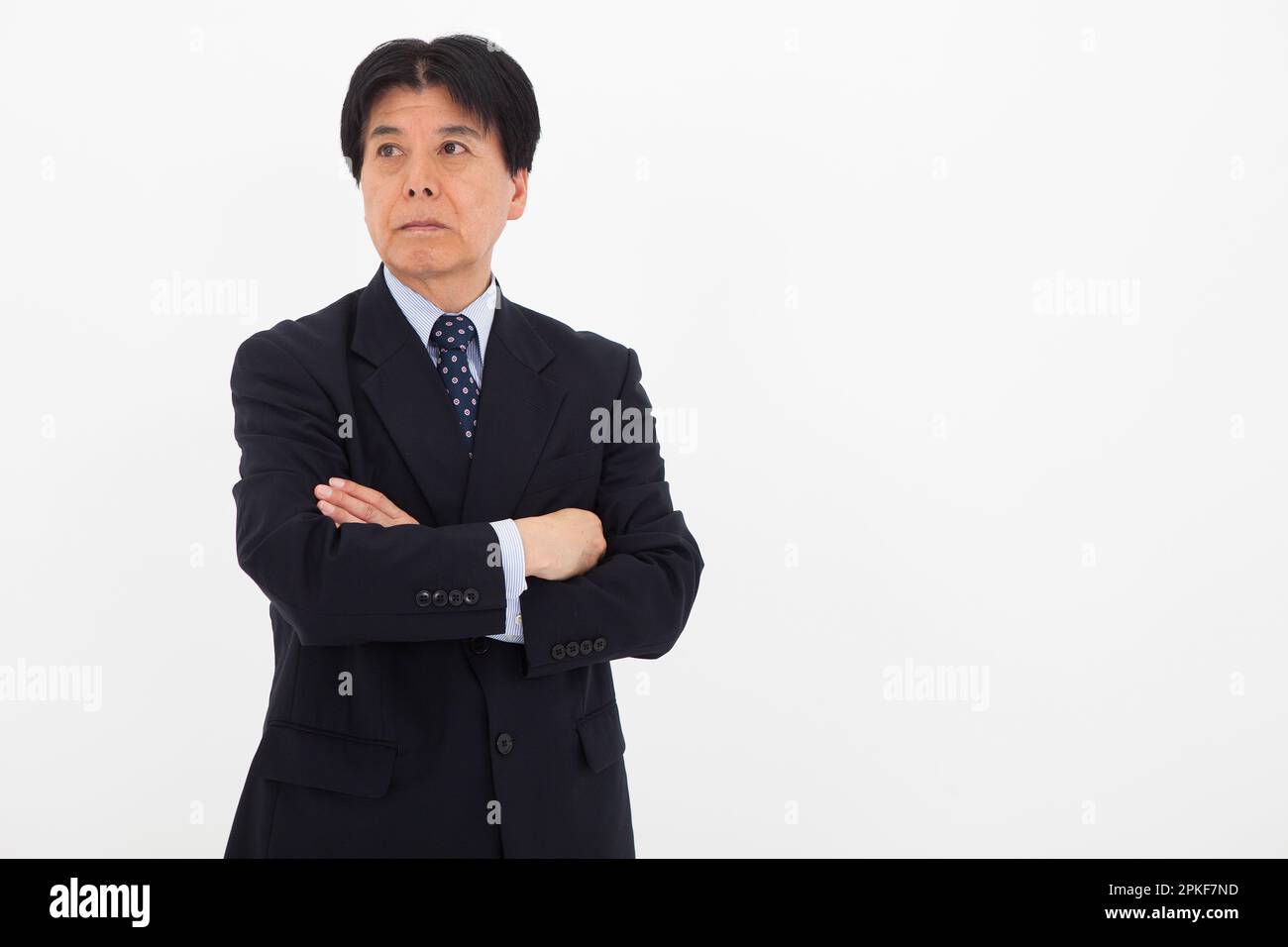 Man crossing arms in suit hi-res stock photography and images - Alamy