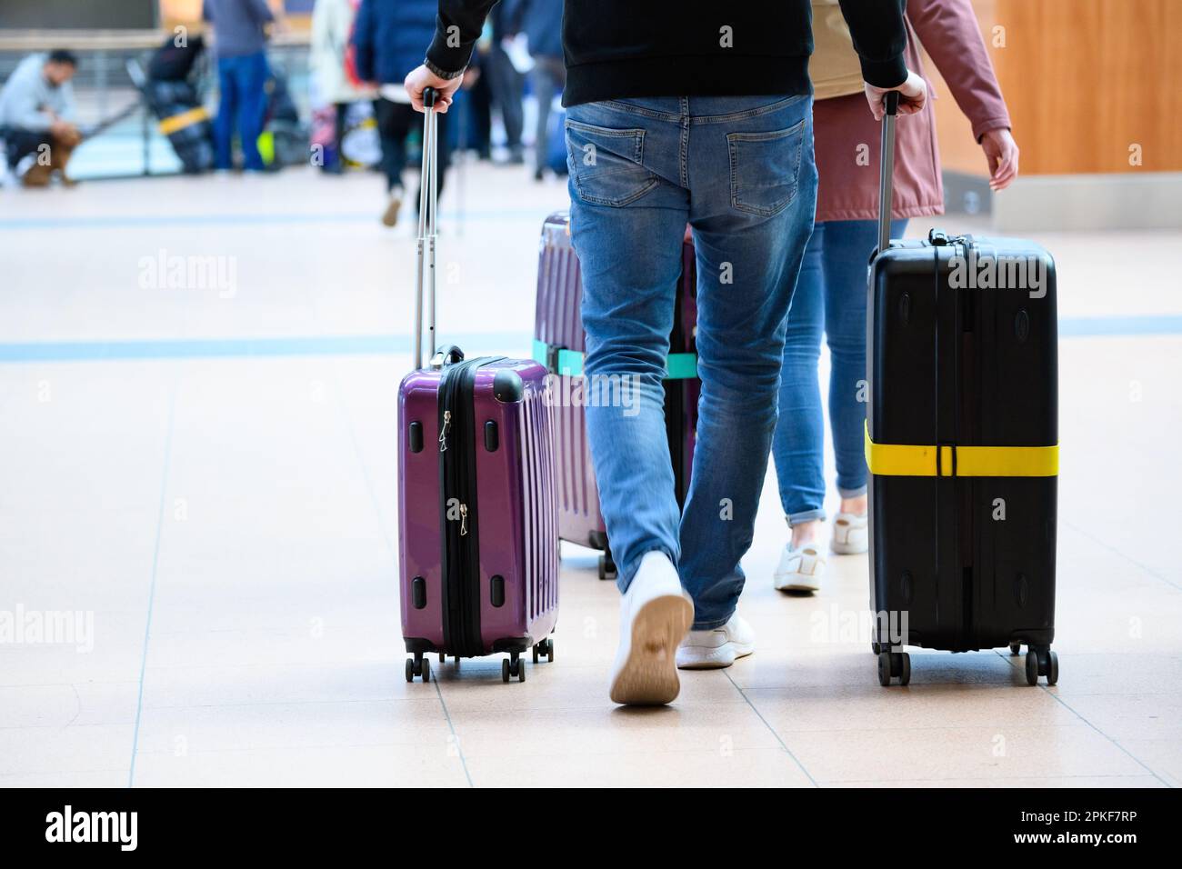 Hamburg, Germany. 07th Apr, 2023. Travelers push their rolling suitcases through Terminal 2 at Hamburg Airport. Credit: Jonas Walzberg/dpa/Alamy Live News Stock Photo