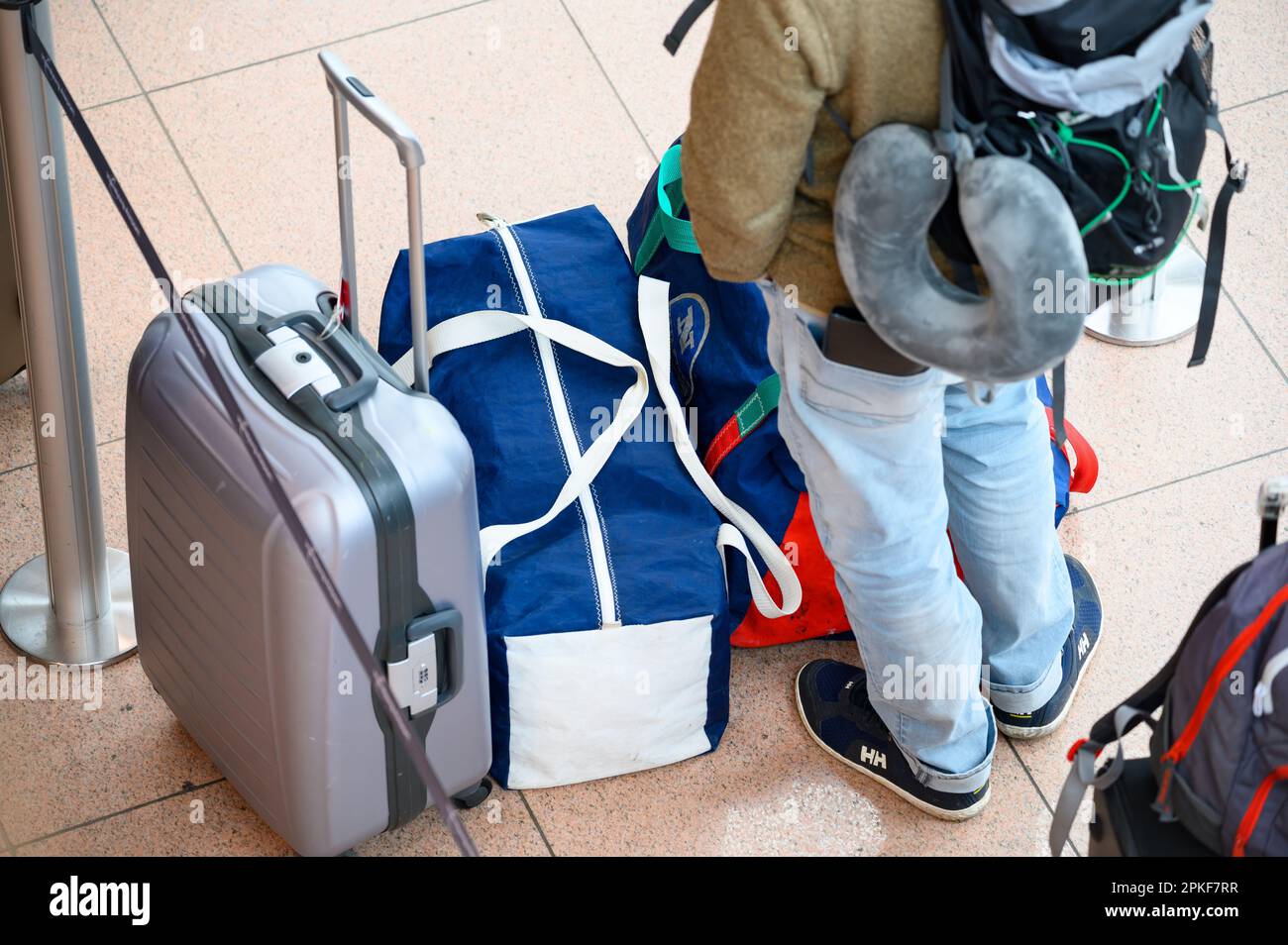 Hamburg, Germany. 07th Apr, 2023. A traveler stands in line with his luggage in Terminal 1 at Hamburg Airport. Credit: Jonas Walzberg/dpa/Alamy Live News Stock Photo