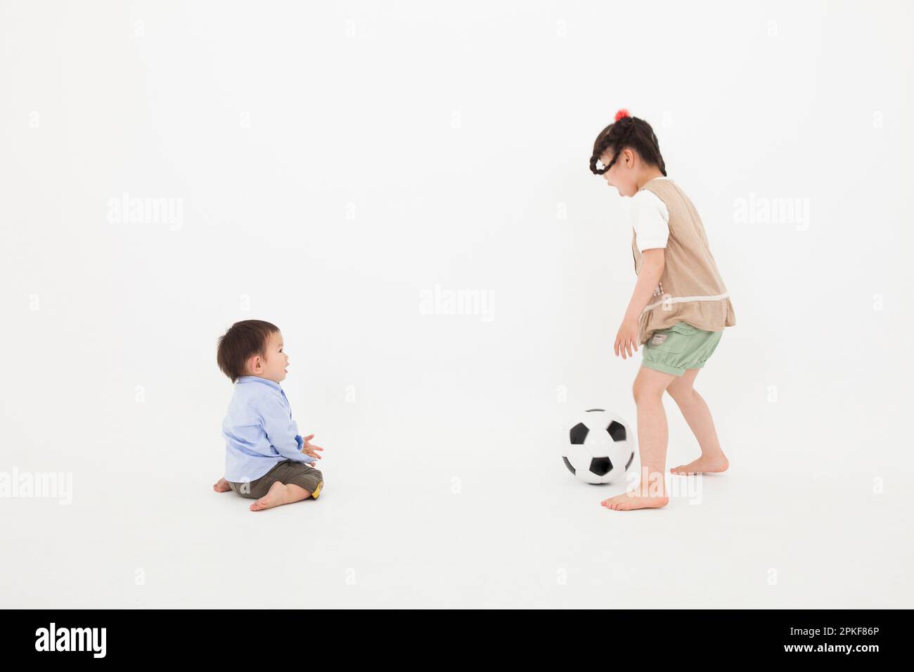Boy and girl playing with soccer ball Stock Photo