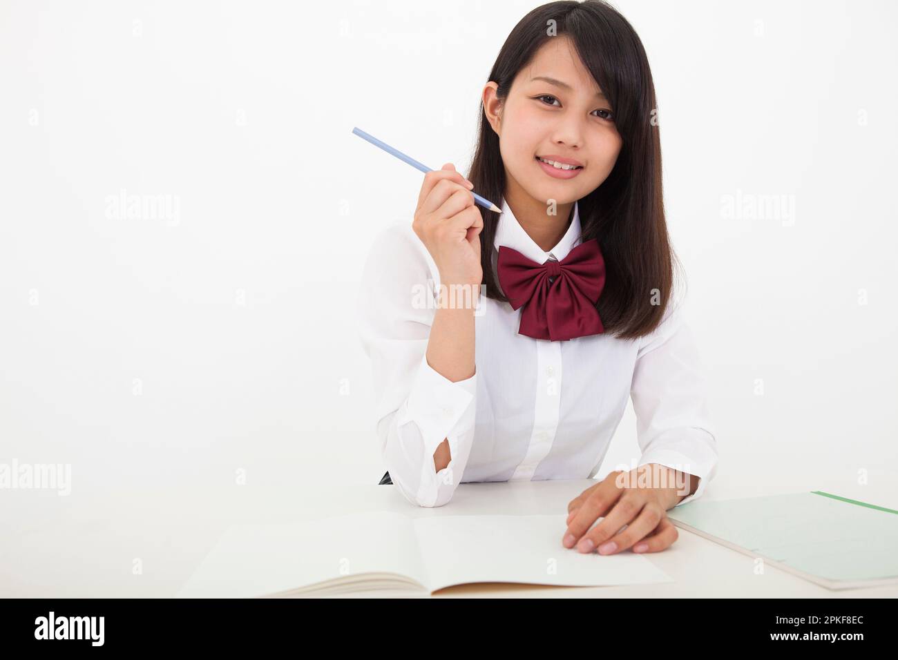 High school student holding a pencil Stock Photo - Alamy