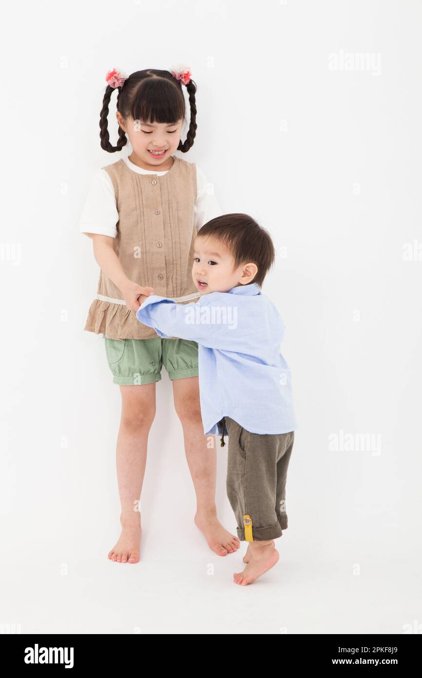 Boy and girl playing close together Stock Photo