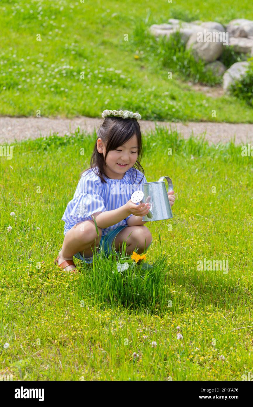 Girl Watering Flowers Stock Photo - Alamy