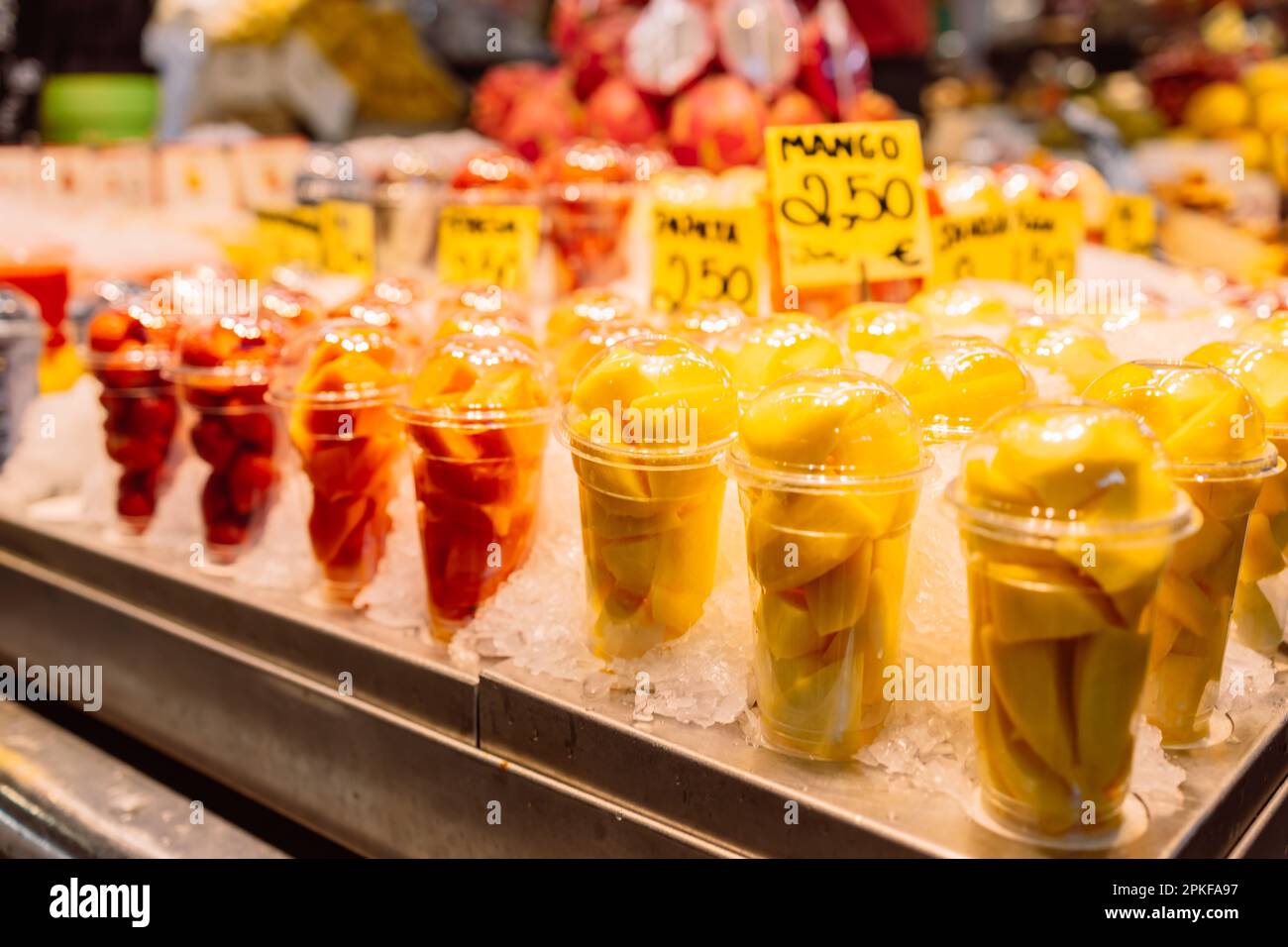 Assortment of fresh cut fruit in plastic containers in market grocery
