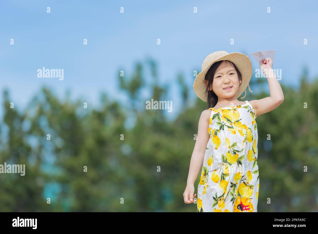 Girl flying a paper airplane Stock Photo - Alamy