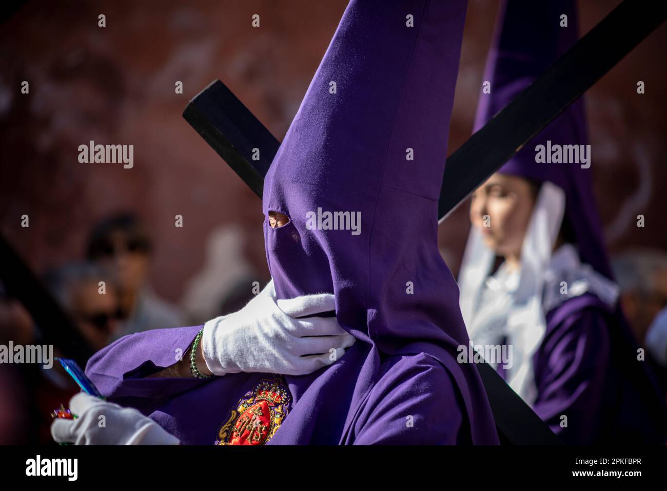 Nazareno with the cross and the hood in the Good Friday procession of