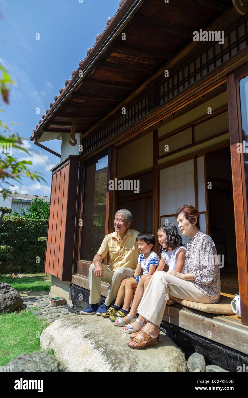An elderly couple and their grandchildren sitting on the porch Stock ...