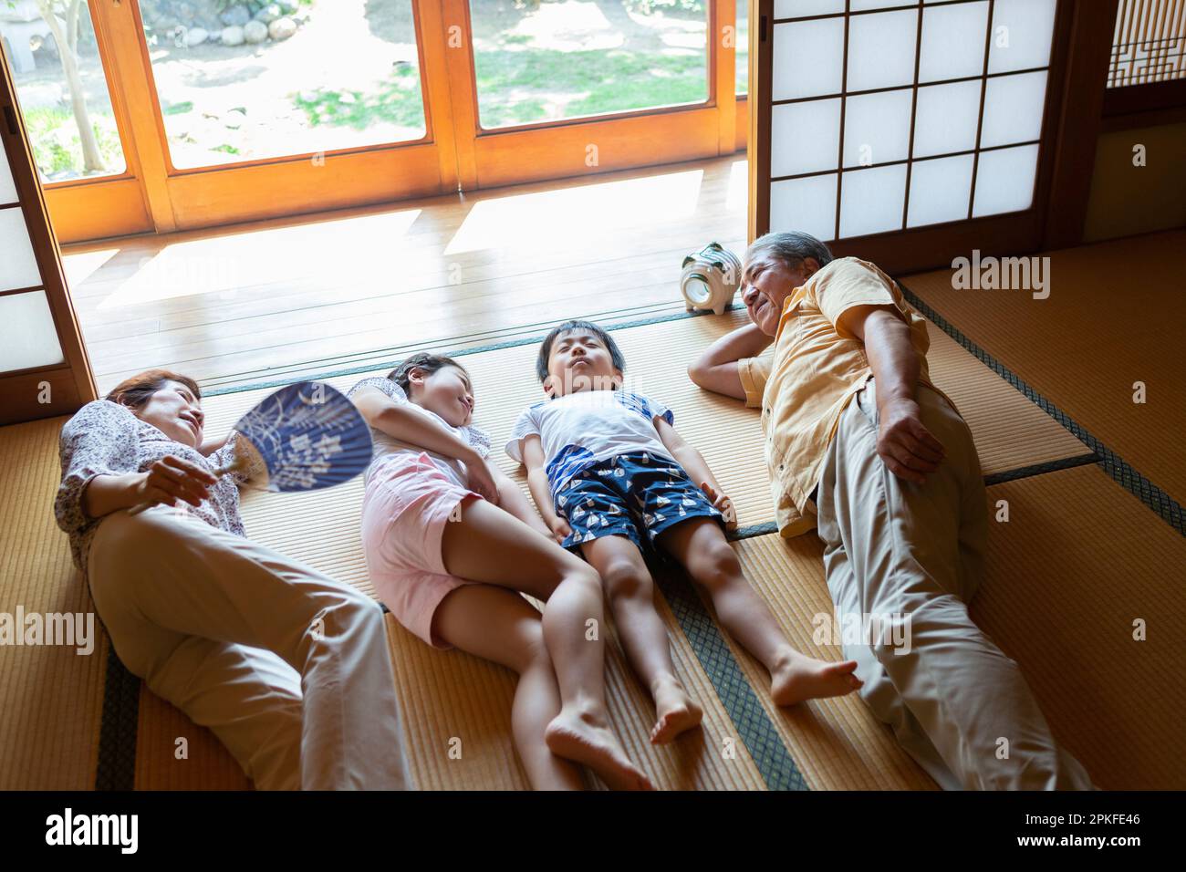 Grandparents and grandchildren taking a nap in a Japanesestyle room