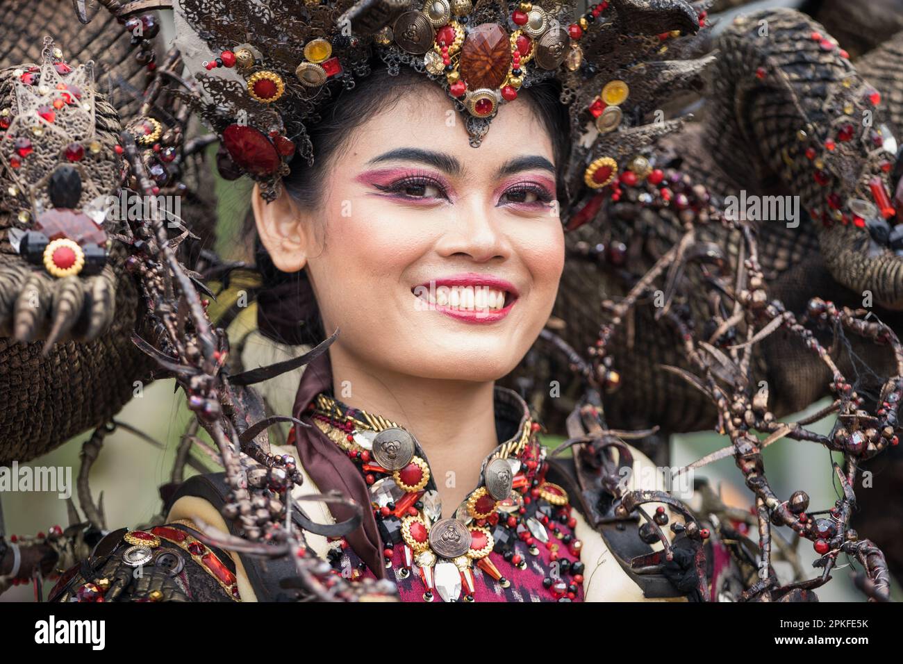 Indonesian woman wearing a costume from Jember Fashion Carnaval smiling at the camera Stock Photo
