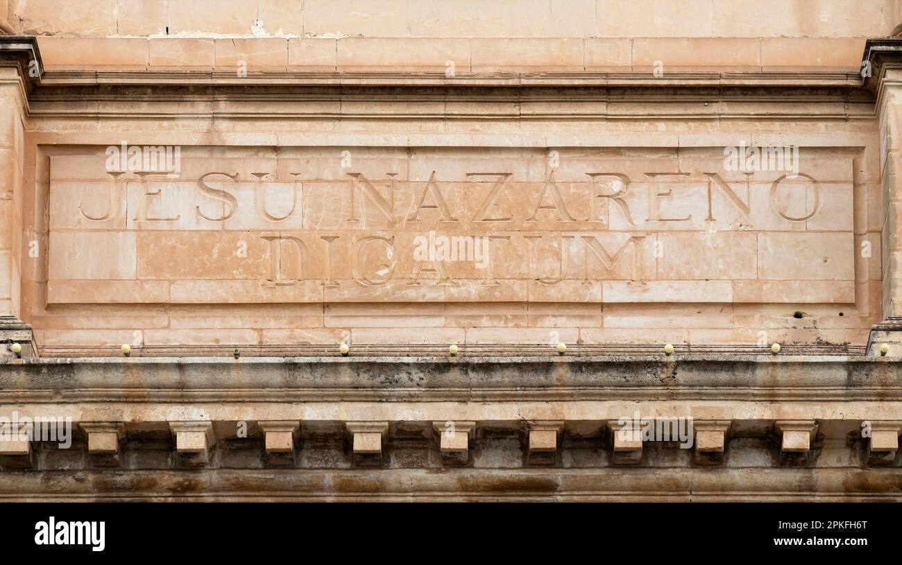 Sliema, Malta - November 12, 2022: Carved dedication text in latin  on Jesus of Nazareth parish Church Stock Photo
