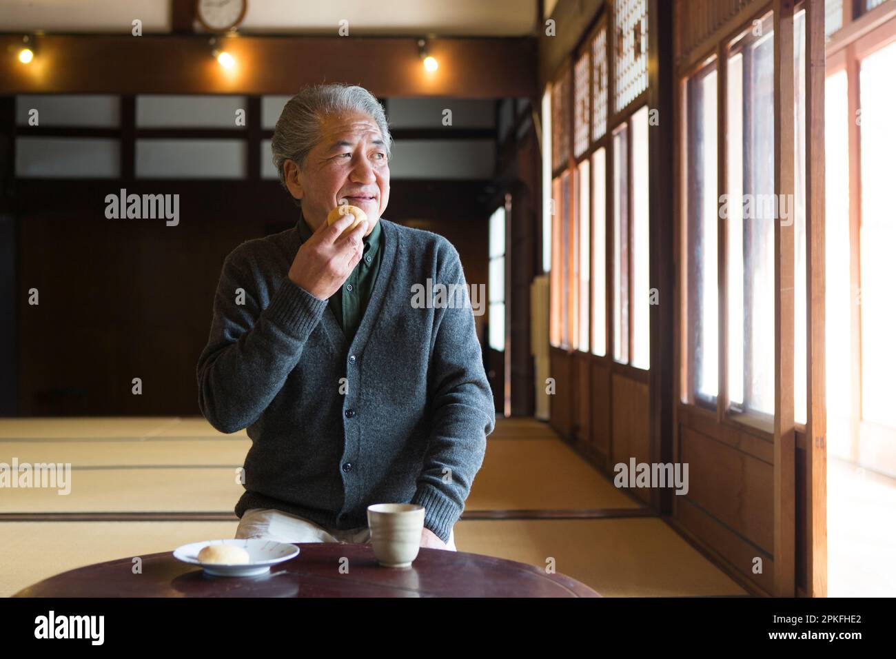 Senior man drinking tea at an old private house Stock Photo