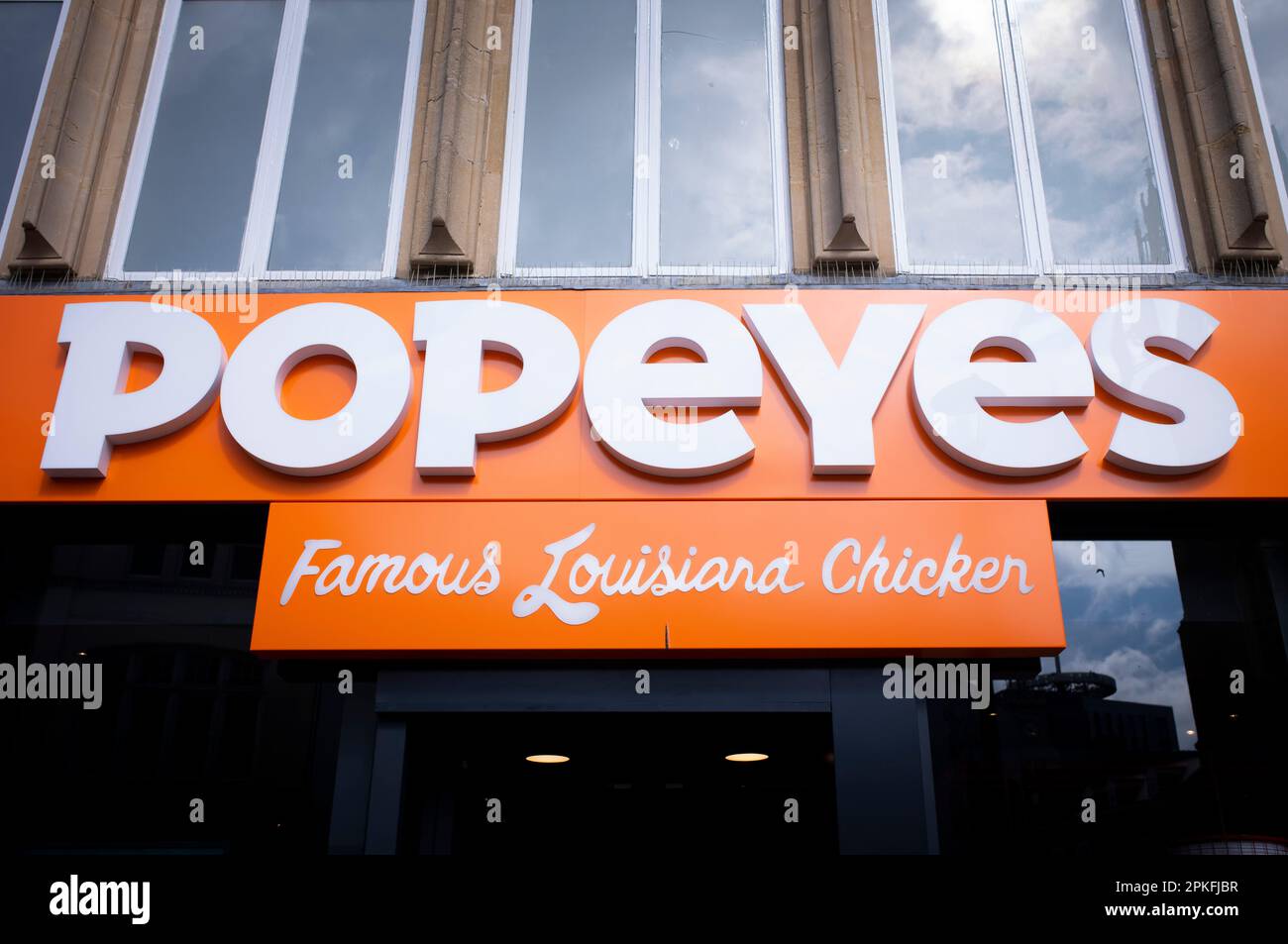 A closeup of the Popeyes chicken restaurant sign in Cardiff, United