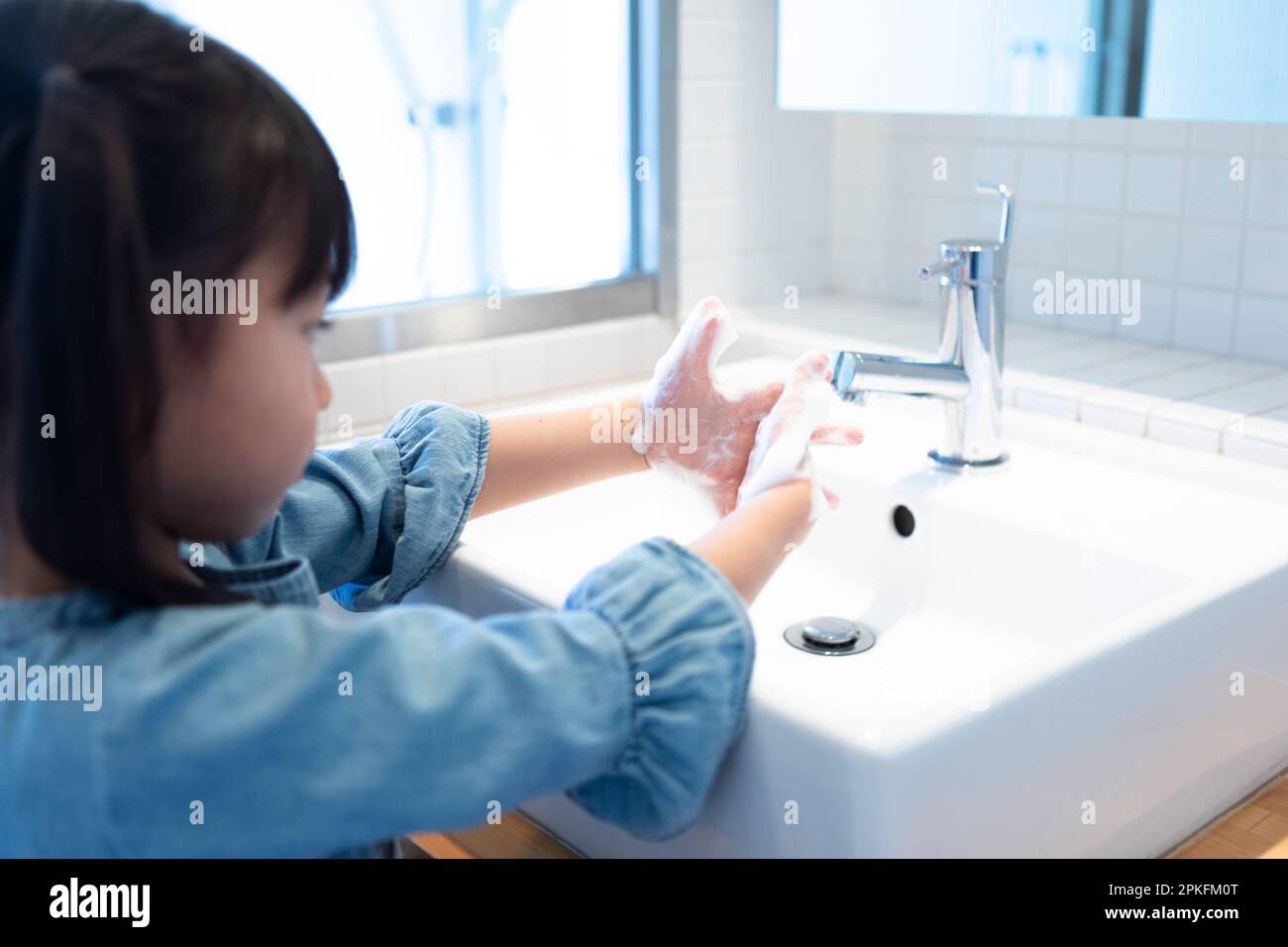 Girl washing her hands Stock Photo