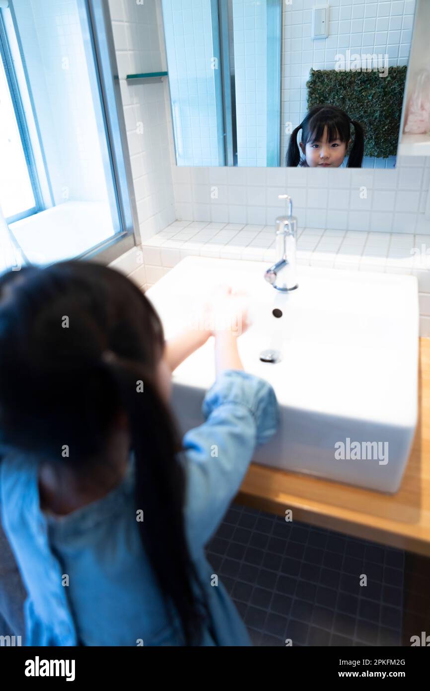 Girl washing hands Stock Photo