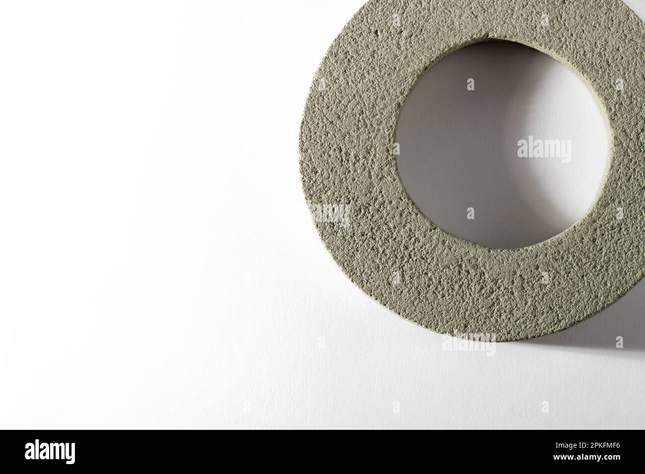 Top view of round shaped cement ring with hole in middle placed on white background Stock Photo