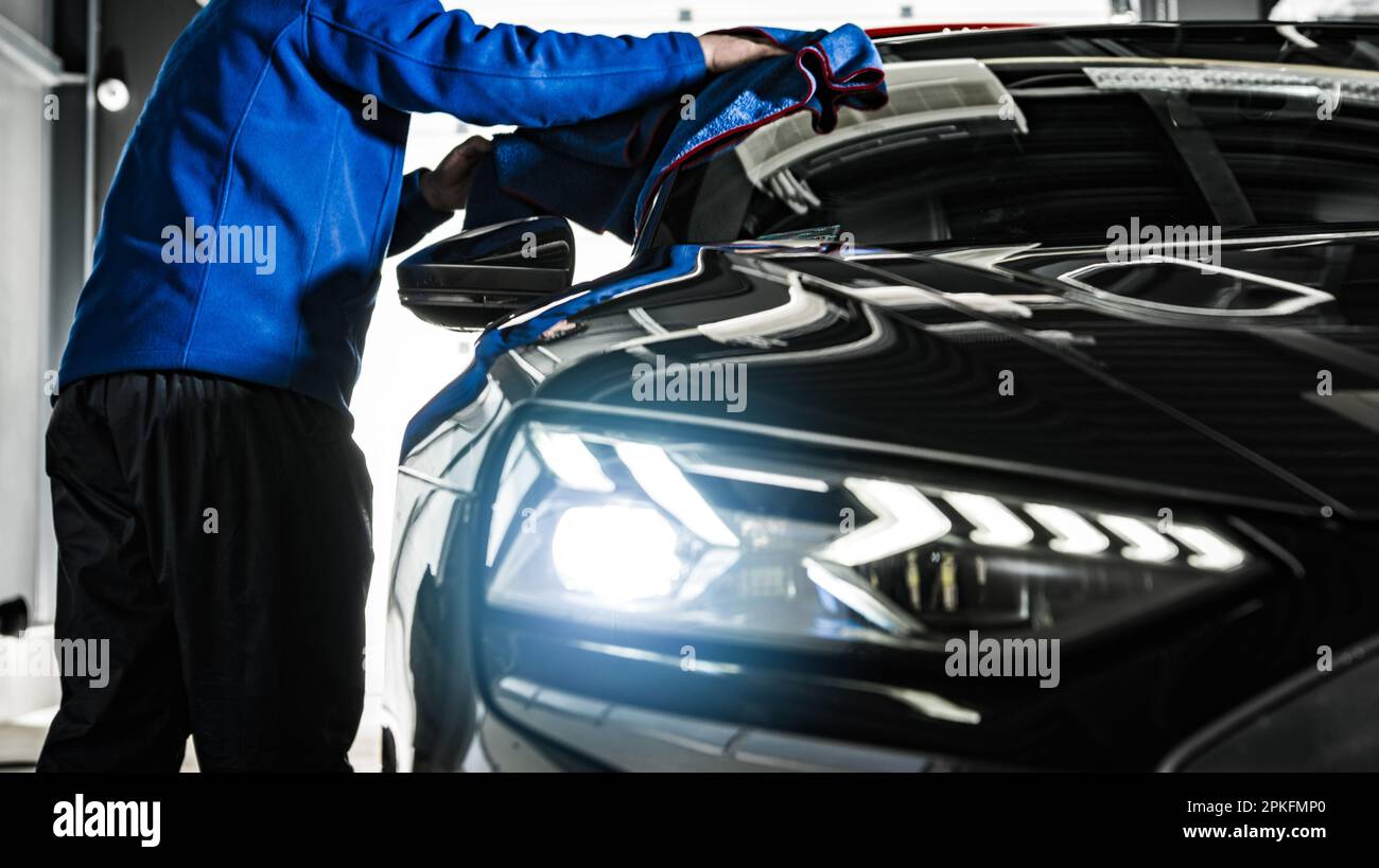 Vehicle Detailer Cleaning Modern Luxury Car Using Soft Cloth