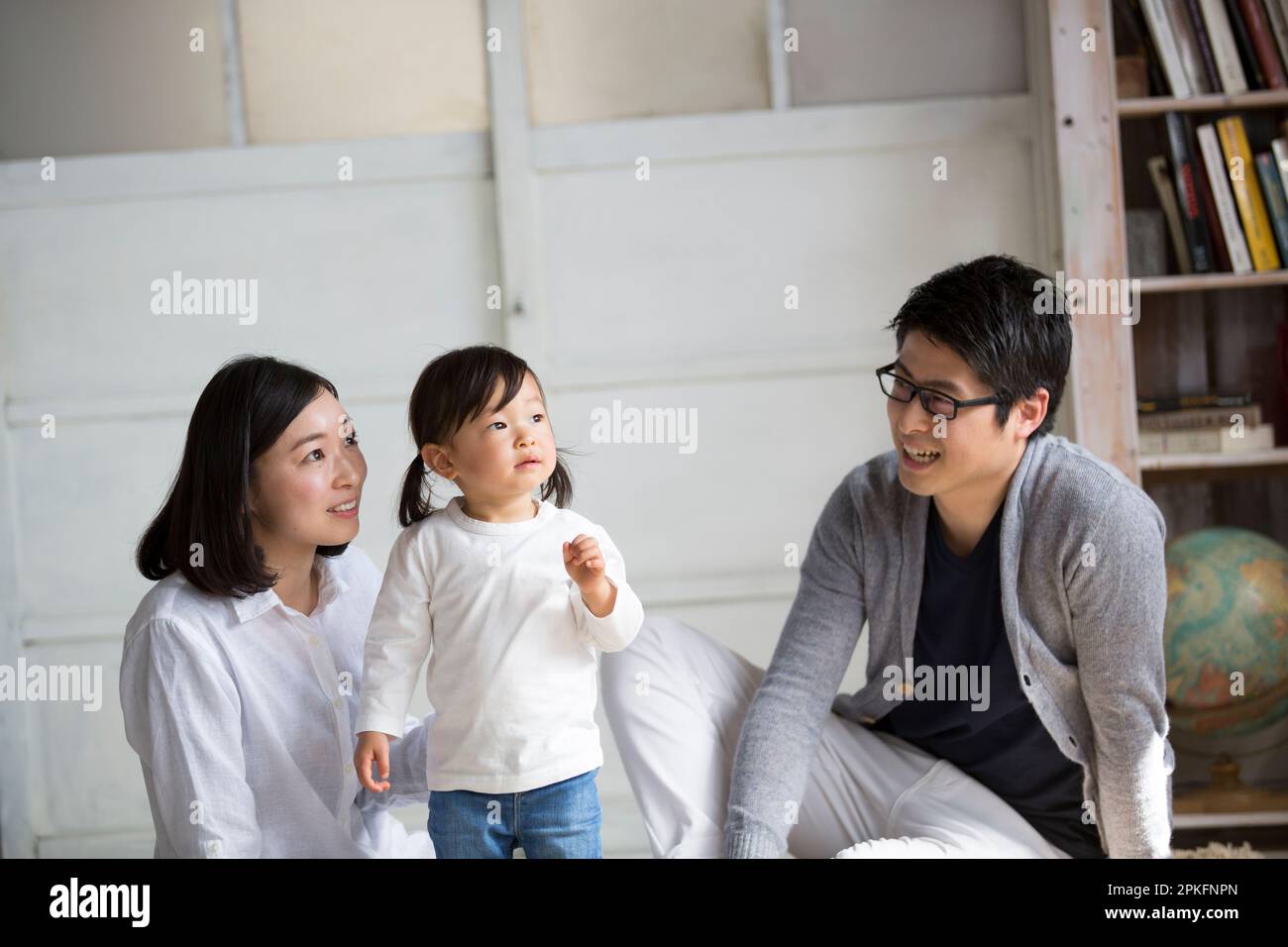 Family in the living room Stock Photo - Alamy