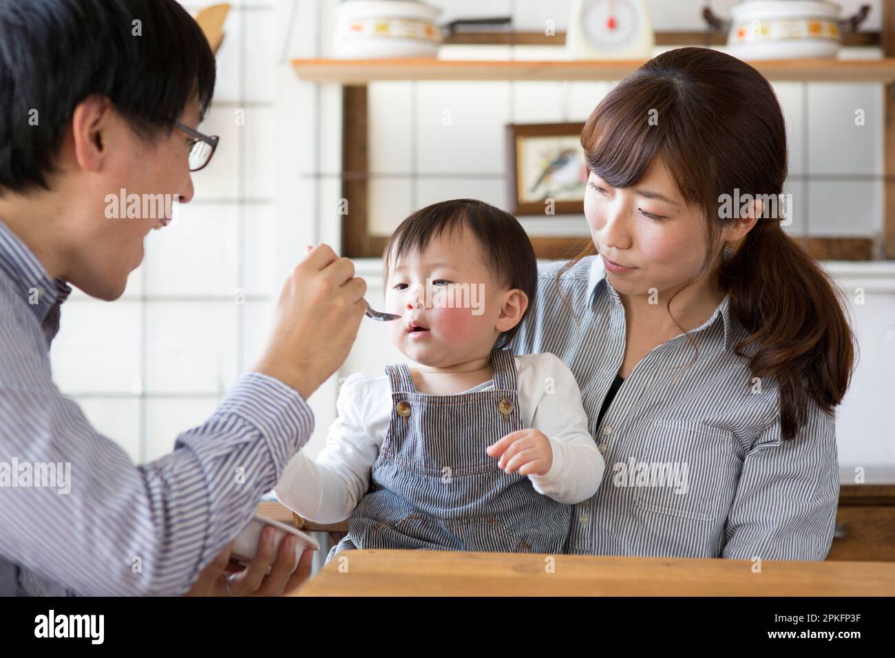 Parents feeding their children Stock Photo