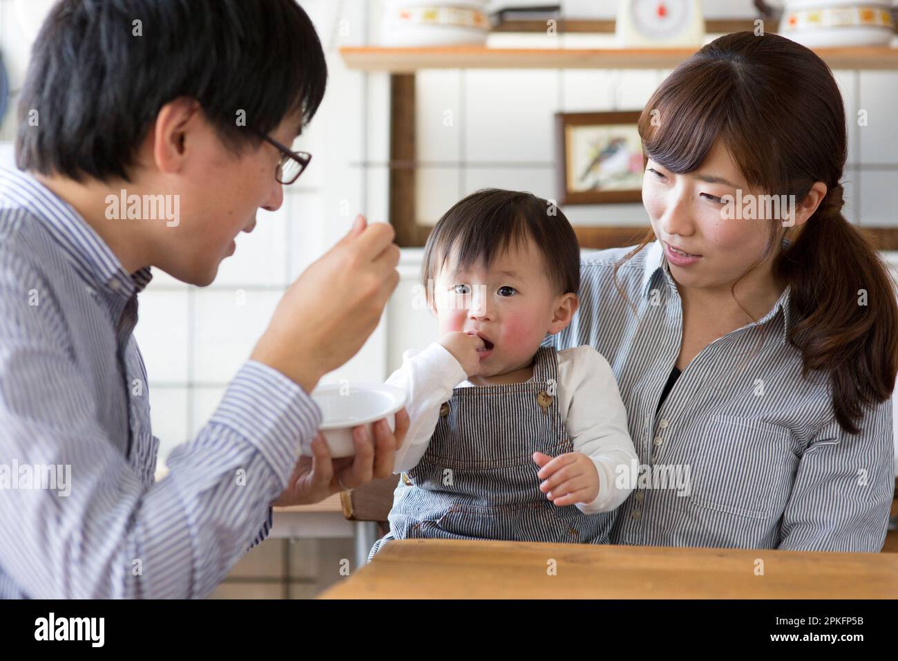 Parents feeding their children Stock Photo